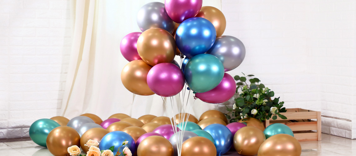 A large, beautiful balloon arch with pastel colors at an outdoor event.